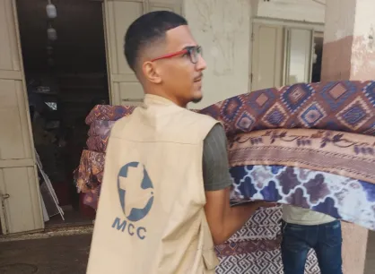 Man carries mattresses